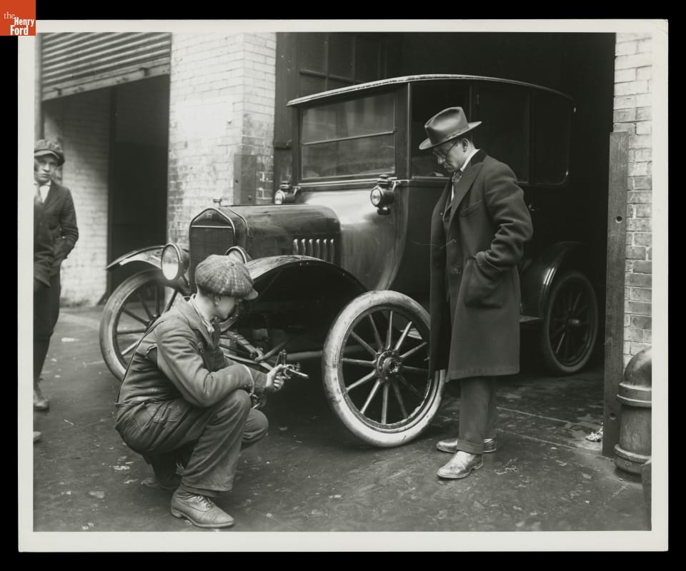Repairing Automobile Wheel While the Customer Waits, circa 1919