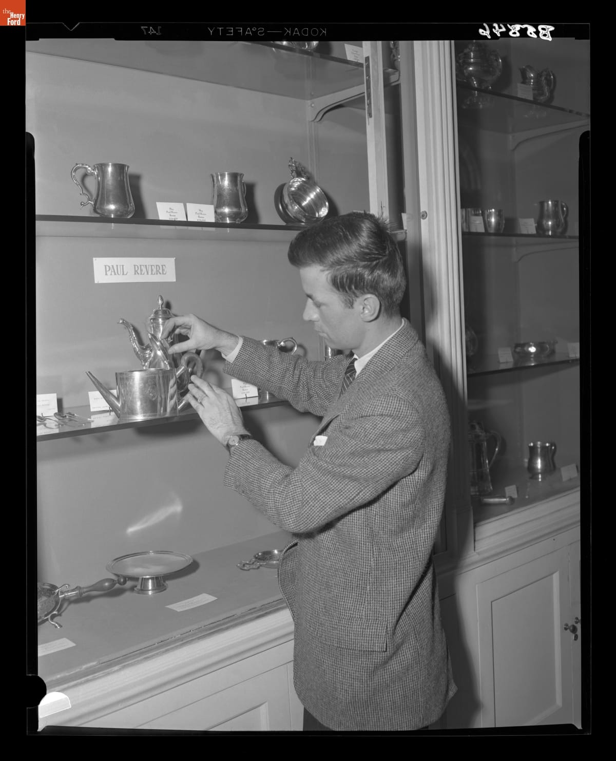 Gerald Gibson Examining Paul Revere Silver in Henry Ford Museum, March 1954