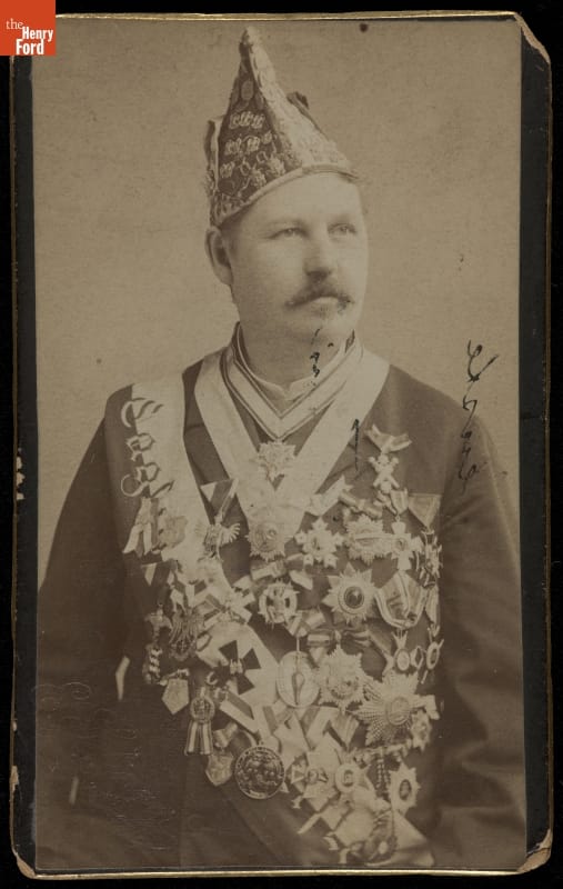 Fraternal Organization Member Wearing Sash, Medals, and Cap, circa 1890