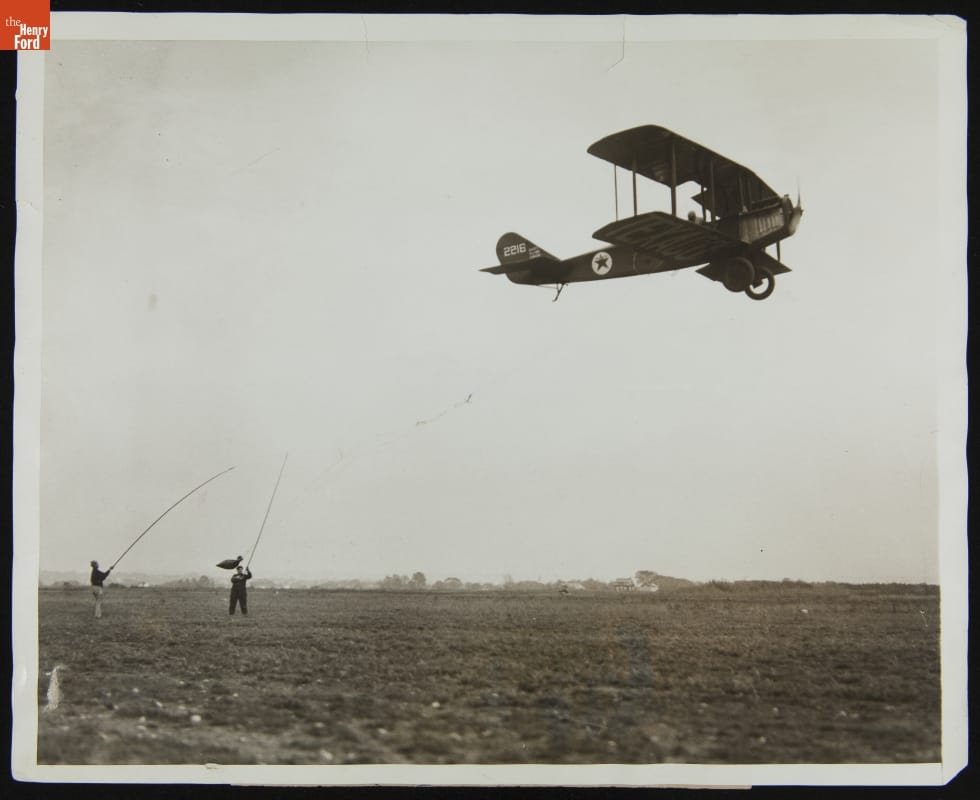 Air Mail Plane Picking Up Mail Bag, Teterboro, New Jersey, 1928, "For Speeding up Your Air Mail!"