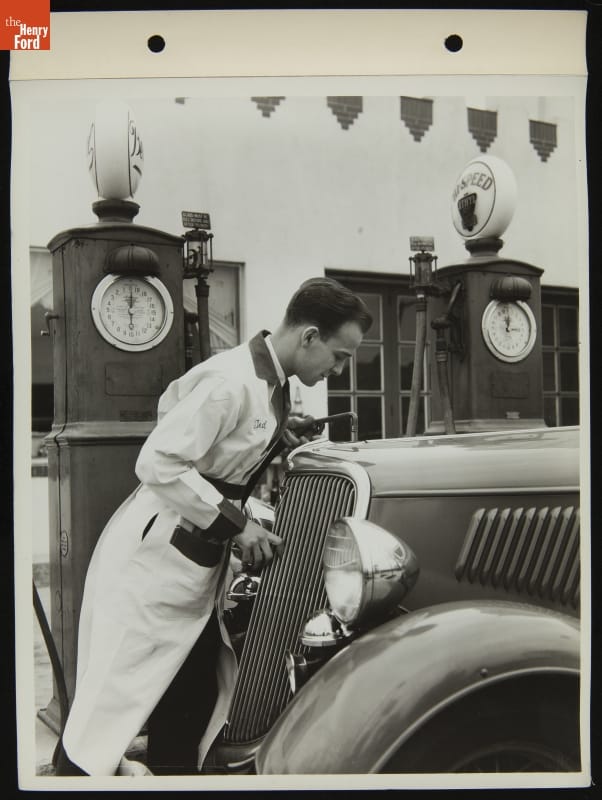 Service Attendant Adding Water to Radiator of a Ford V-8 Car, April 1935