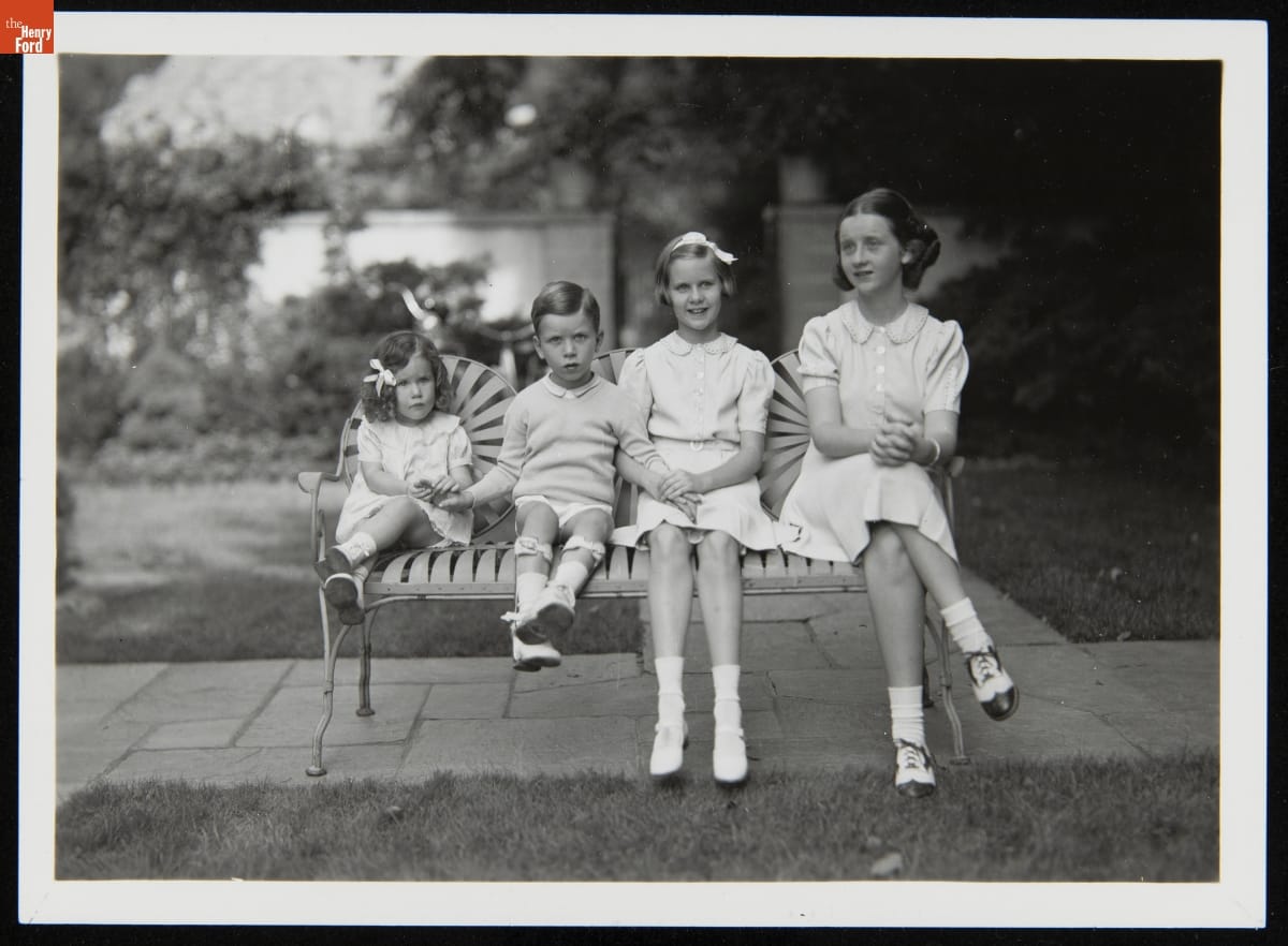 Anne, Harvey III, Martha, and Elizabeth Firestone Seated Together on a Bench, circa 1936