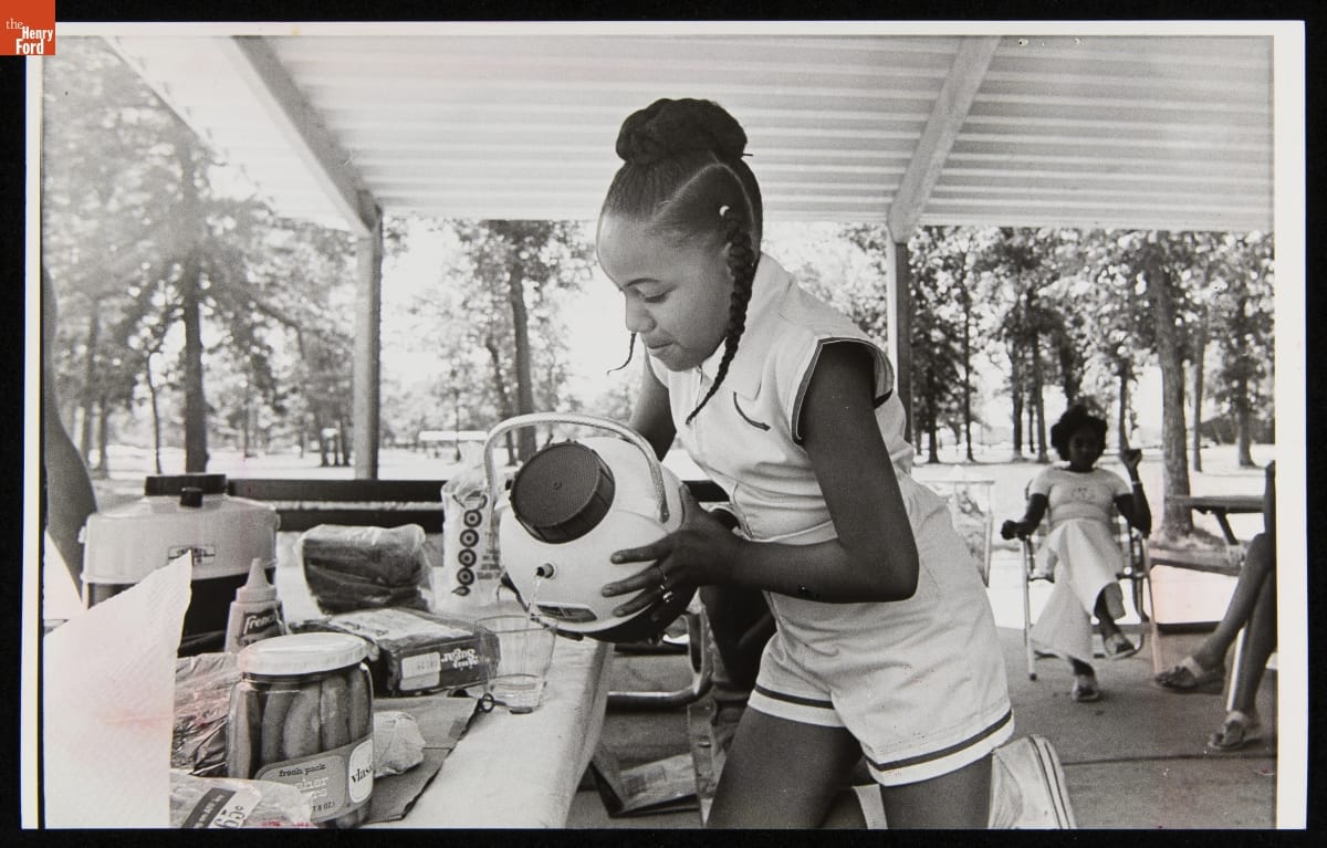 Tosha Carter Pouring a Drink from a Cooler at a Family Picnic, Belle Isle, Detroit, Michigan, June 21, 1977