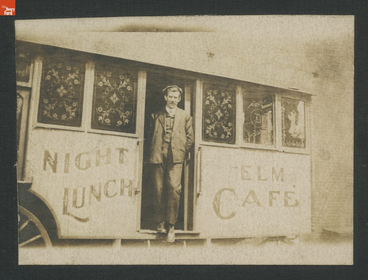 Man in Doorway of "Night Lunch Elm Cafe" Lunch Wagon