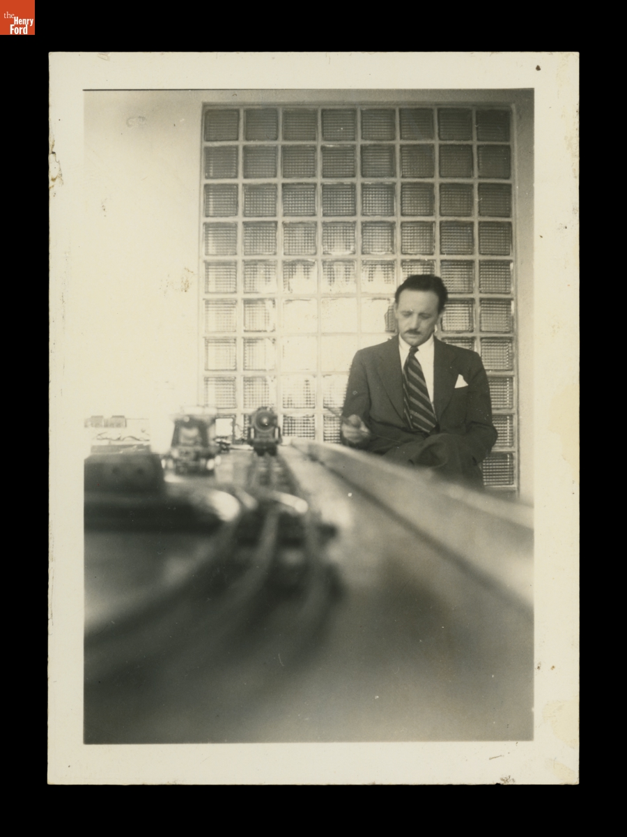Gilbert Rohde Seated at a Model Train Table