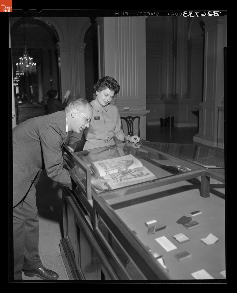 Librarian Kenneth Metcalf and Guide Lela Henry View the "Strange and Curious Books" Exhibit in Henry Ford Museum, September 1960