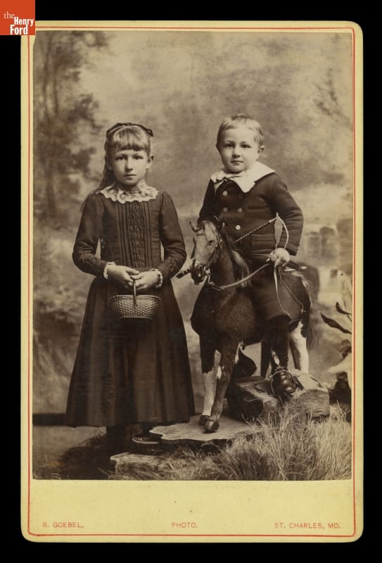 Girl and Boy Posed with Basket and Rocking Horse, 1880